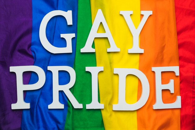 Gay pride lettering on rainbow flag