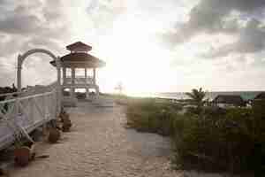 Foto gratuita gazebo sulla spiaggia al tramonto