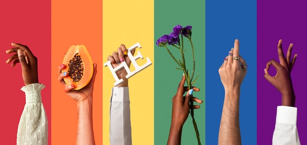 Gender fluid people hands on rainbow background