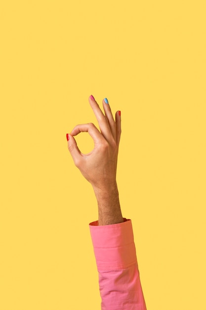 Free photo gender fluid person hand isolated on yellow