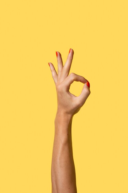 Gender fluid person hand isolated on yellow