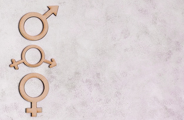 Gender signs on marble background with copy space