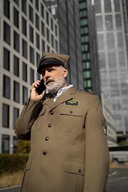 Free photo general talking on phone side view