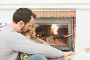 Free photo gentle couple embracing near fireplace