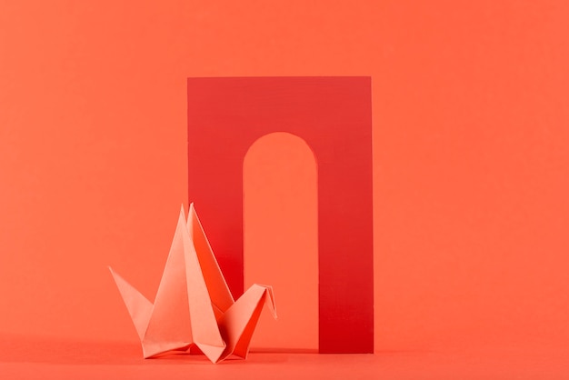 Geometric paper shapes on coral background