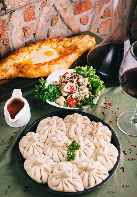 Georgian khinkali with salad sauce and tandir bread.