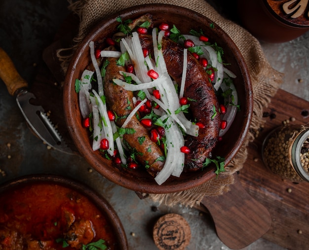 Georgian kupat with onions and pomegranate in earthenware