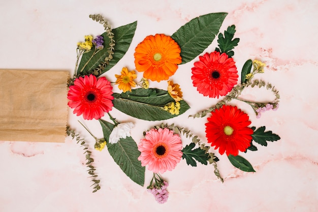 Gerbera flowers with green leaves and branches 