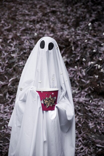 Ghost holding popcorn box with dropping grains