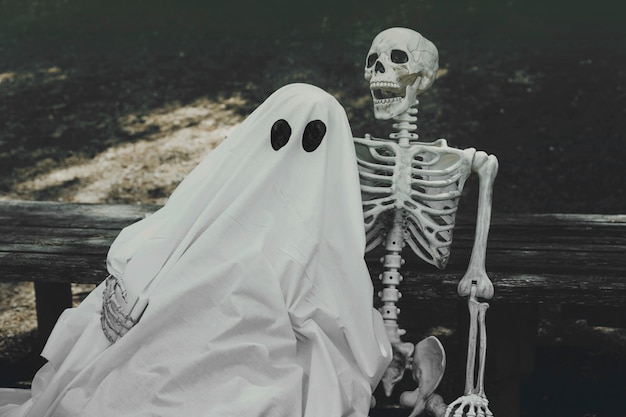 Ghost and skeleton hugging on bench 