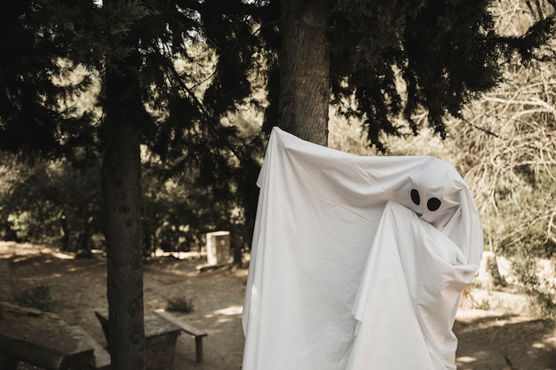 Free photo ghost waving off arms in park