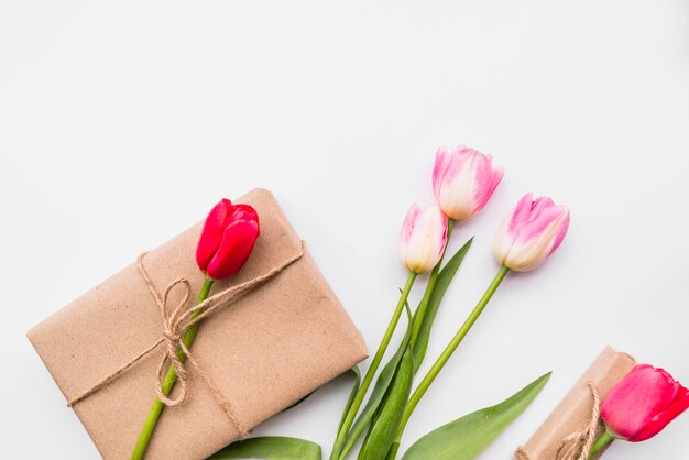 Gift box and bunch of bright flowers