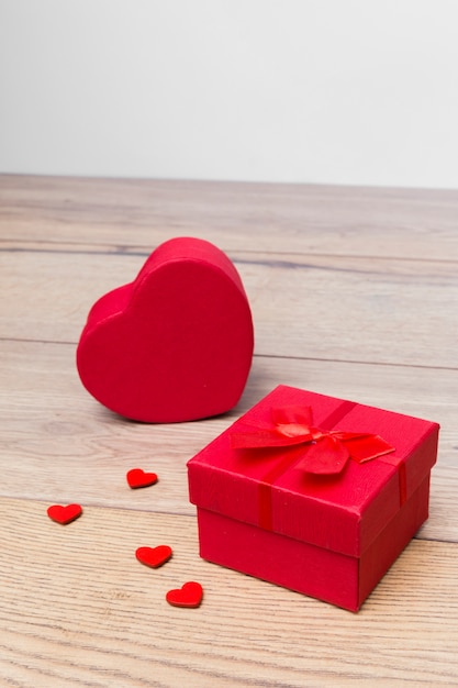 Gift box in heart shape on wooden table