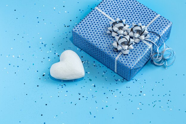 Gift box Packed in blue paper on blue.