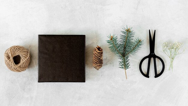 Gift box with Christmas decoration on grey table