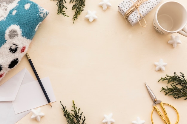 Free photo gift box with green branches on table