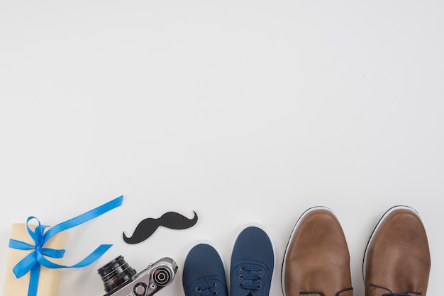 Gift box with man shoes, camera and mustache