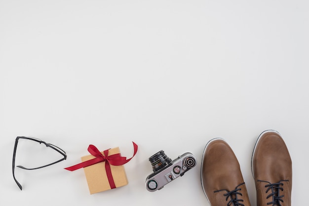 Gift box with man shoes and camera 