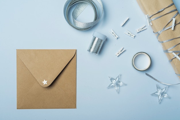 Gift box with small envelope on table