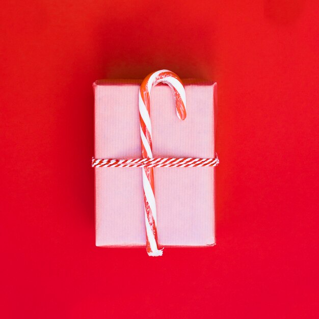 Gift box in wrap with candy cane 