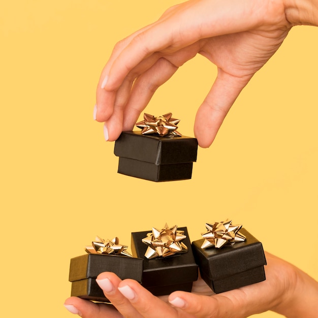 Gift boxes with golden ribbon for black friday side view