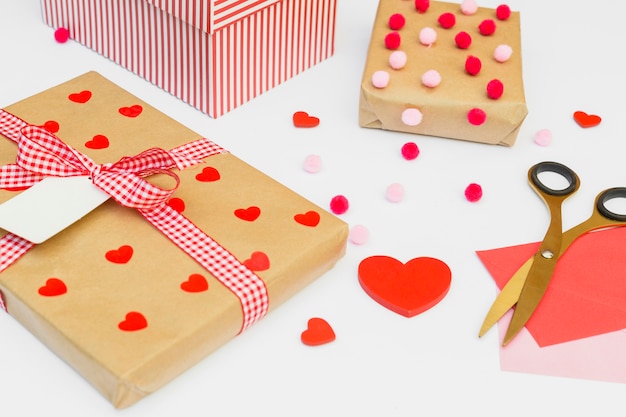 Gift boxes with red heart on light table