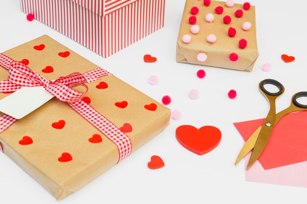 Gift boxes with red heart on light table