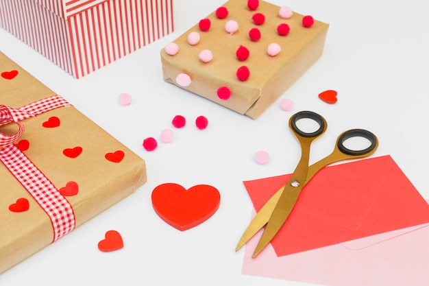 Gift boxes with red heart on white table