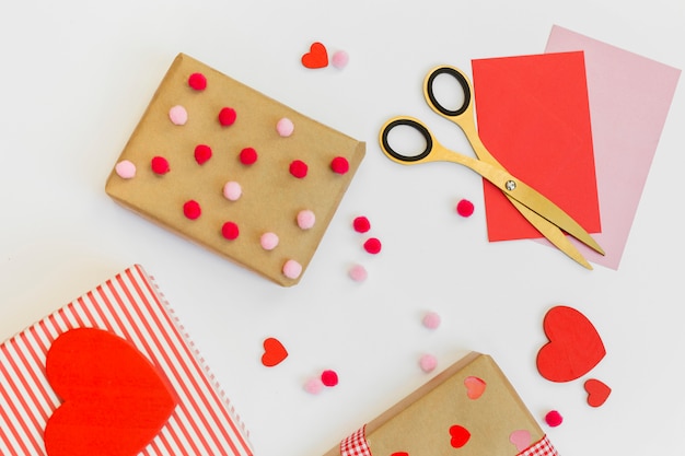 Gift boxes with red hearts and envelopes on table