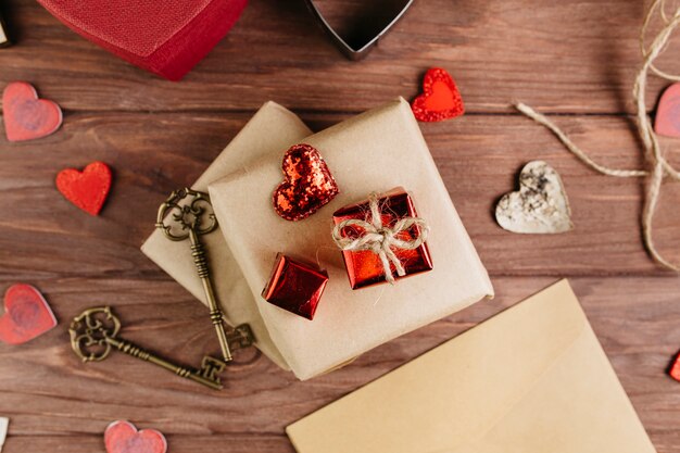 Gift boxes with small hearts on wooden table