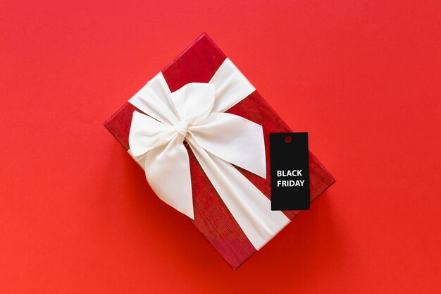 Gift with black friday tag on plain background