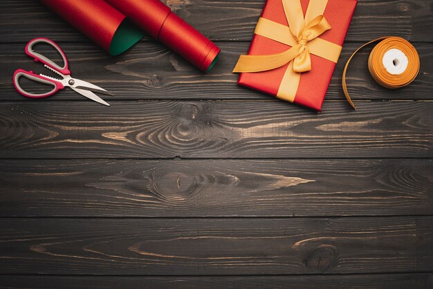 Gift with golden ribbon on wooden background and copy space