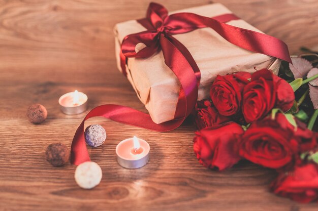 Gift with lighted candles and roses