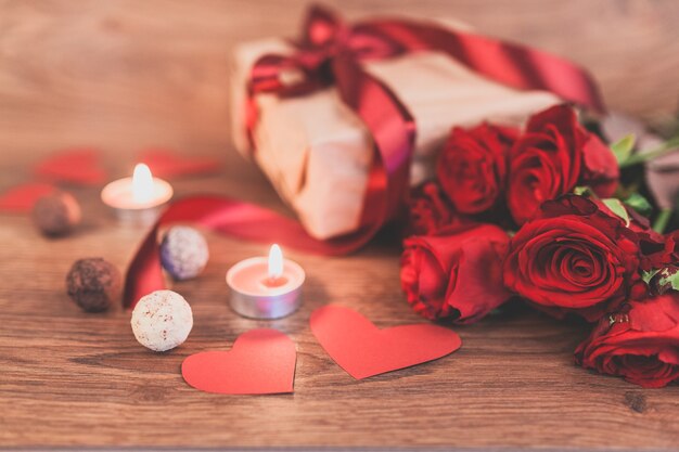 Gift with lighted candles and roses