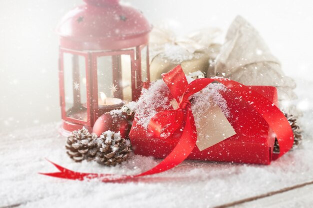 Gift with a red tie and an antique lamp