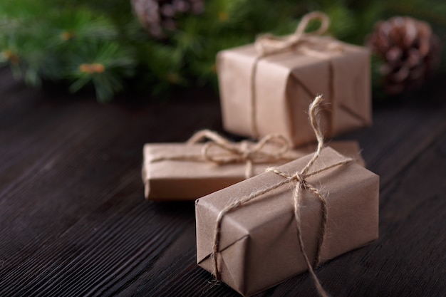 Gifts brown with a string and a roll of string and pine leaves background