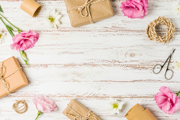 Gifts; flowers and scissor arranged in circular pattern on table