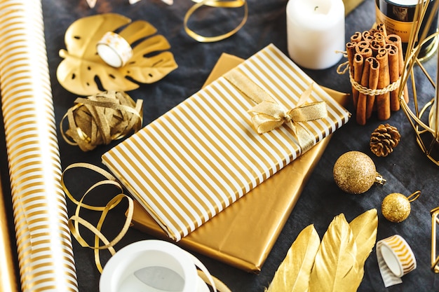 Gifts wrapped in golden paper on table