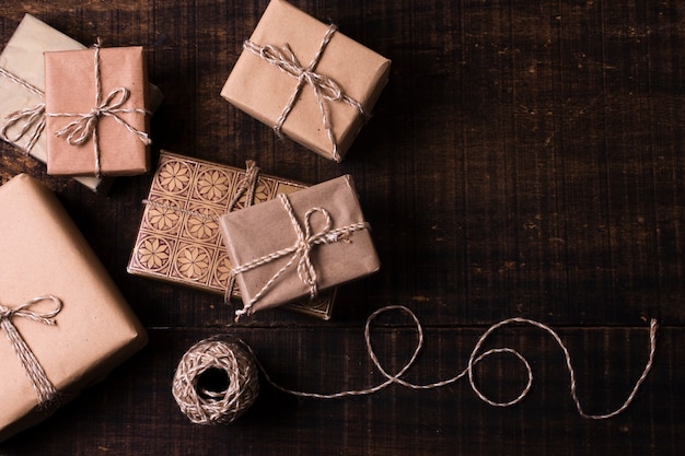 Gifts wrapped in paper with wooden background