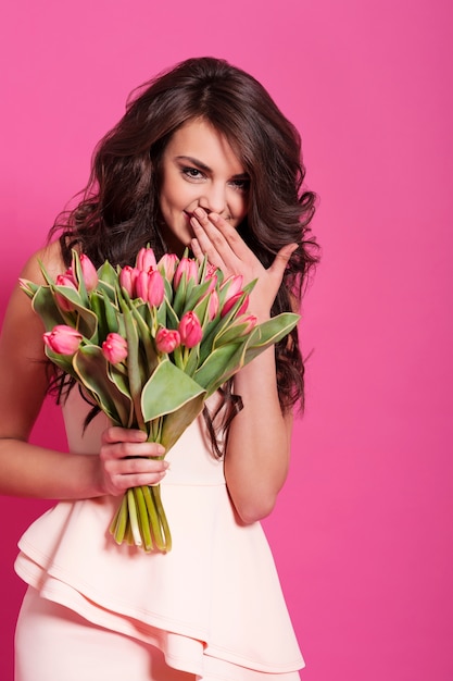 Giggle beautiful woman with freshness flowers