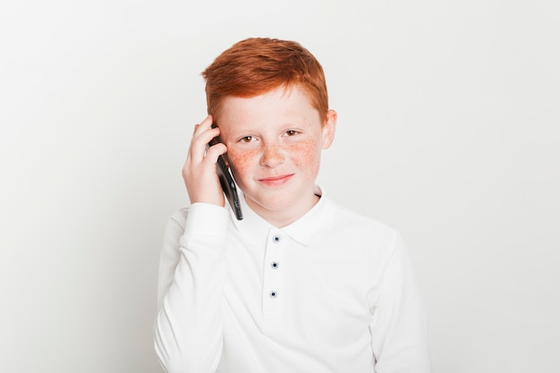 Ginger boy making phone call