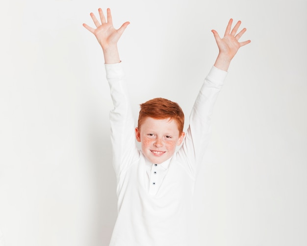 Ginger boy raising his hands