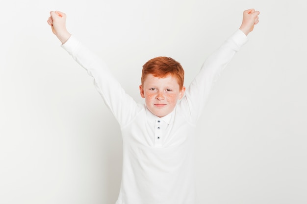 Free photo ginger boy with arms raised