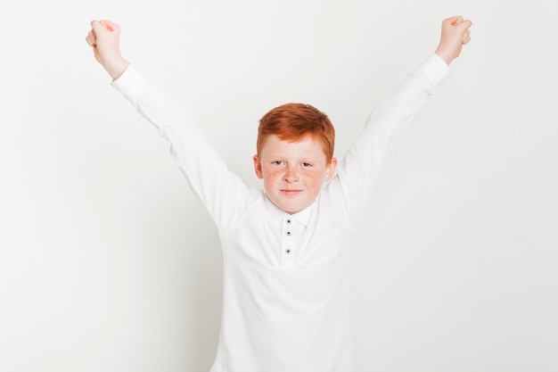 Ginger boy with arms raised