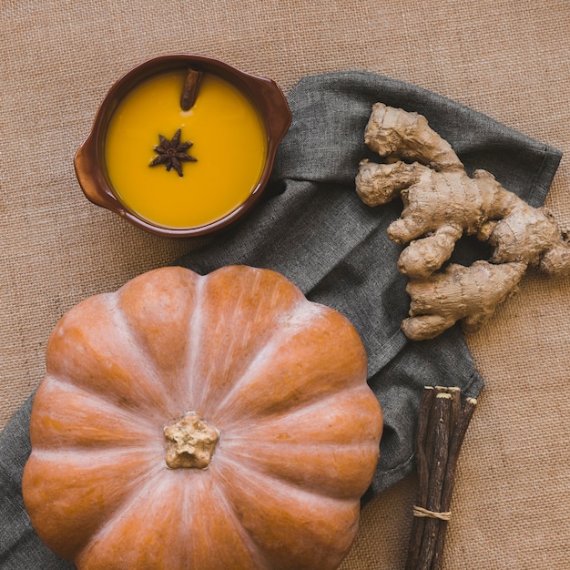 Ginger and pumpkin near soup and sticks