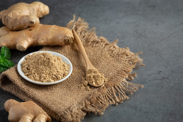 Ginger root and ginger powder on table
