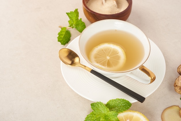 Ингредиенты имбирного чая, полезный успокаивающий и нагревающий чай по простому рецепту. Имбирный чай и ингредиенты - лимон, мед. Вид сверху. Плоская планировка. только что из домашнего органического сада. Концепция питания.