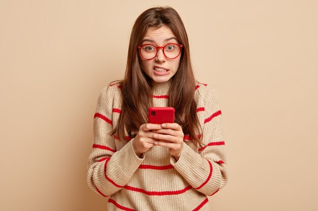 Ginger teenager wearing red eyeglasses