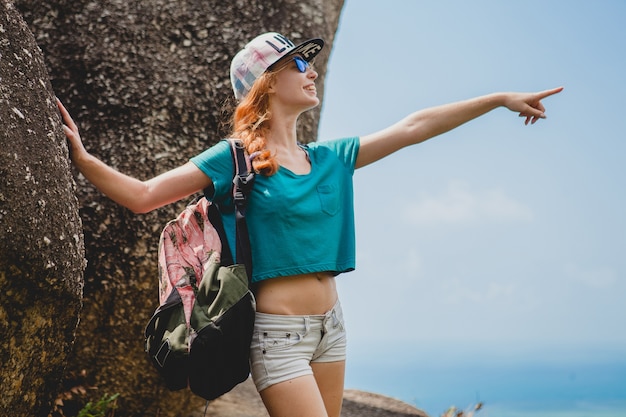 Ginger woman traveling in mountains, tourist on summer vacation