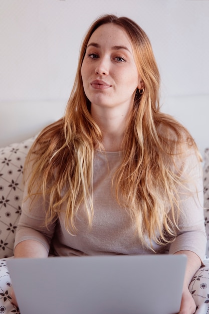 Free photo ginger woman with laptop in bed